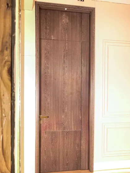 This 10-foot tall Sucupira Balentino veneer door is a statement of luxury and scale, shown here during a restoration to bring out its timeless elegance.