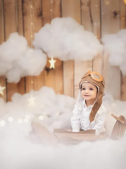 A sweet, curious glance from our birthday boy in his pilot gear. These themed sessions are designed to be fun and engaging for the baby, allowing me to capture their natural expressions.