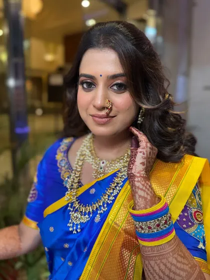 A smiling portrait of the bride, showing off her stunning engagement look. The makeup is flawless and the jewelry is perfectly placed.