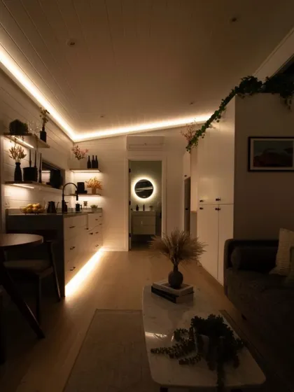 The ambient lighting in this holiday home creates a warm and inviting atmosphere in the evening. I use layered lighting to make spaces feel cozy and sophisticated.