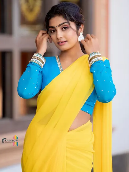A simple and vibrant look. I designed this full-sleeve blue blouse with scattered pearl details to be paired with a bright yellow chiffon saree. It's a fresh and youthful combination.