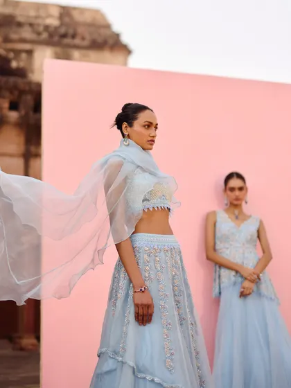 This shot captures the graceful movement of a light organza dupatta. The focus is on the airy, delicate quality of the fabric, which adds a touch of romance to the overall look.