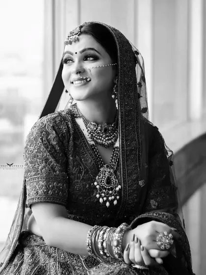 A thoughtful black and white portrait. The bride looks out the window, creating a candid and contemplative mood that is both beautiful and artistic.