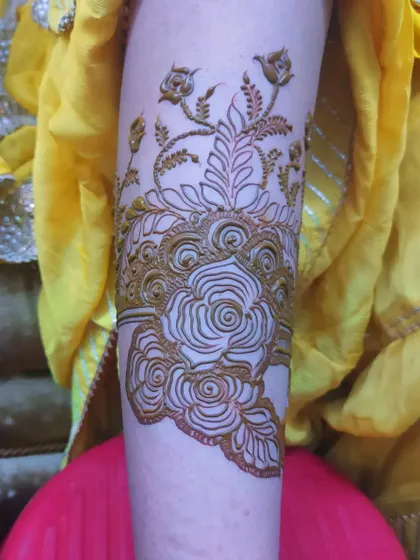 An elegant arm band design with a large central rose, surrounded by delicate budding flowers.