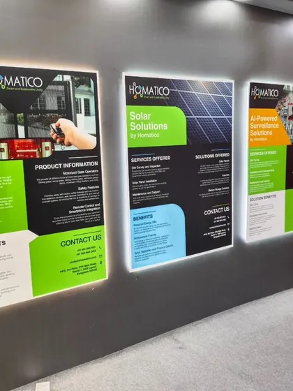 These illuminated posters at our booth detail the services we offer, including Entrance Automation, Solar Solutions, and AI-Powered Surveillance. We aim to be a one-stop shop for all automation needs.