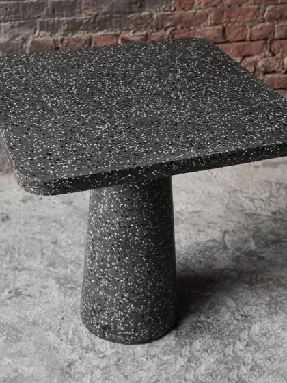 A slightly different angle of the terrazzo cafe table, emphasizing its solid construction and minimalist form.