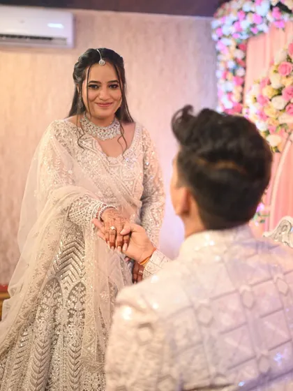 A romantic proposal moment during the ceremony. The bride's makeup is soft and pretty, capturing her emotional and happy expression.