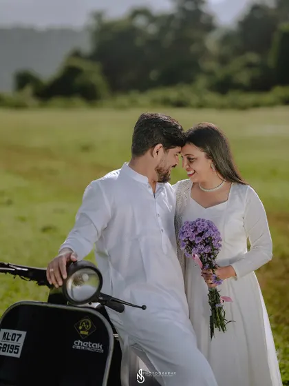 An intimate close-up with the couple and the scooter. The purple bouquet adds a lovely pop of color to the neutral palette.