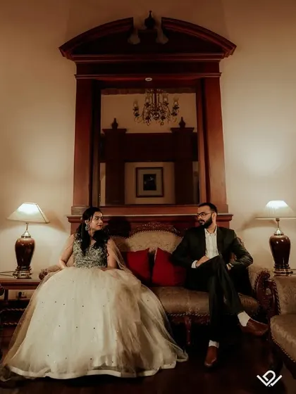 A moody and atmospheric shot of a couple in a grand, dimly lit room, creating a cinematic and dramatic feel.