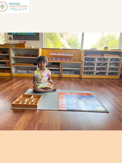 A student sits with her completed Decanomial Square, a significant work that requires patience, concentration, and an understanding of sequence.