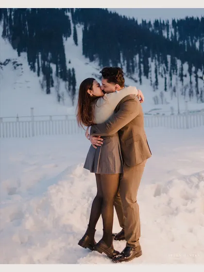 A passionate kiss in the snow. This romantic and cinematic shot perfectly captures the fire of a relationship against a cold, beautiful landscape.