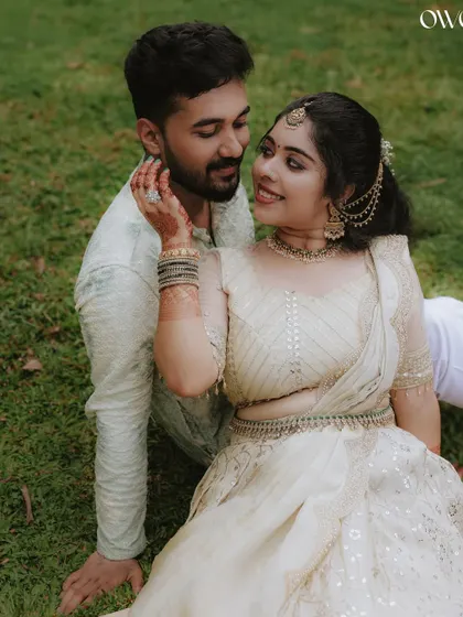 An intimate and loving portrait of a couple sitting together on the grass, lost in their own world.