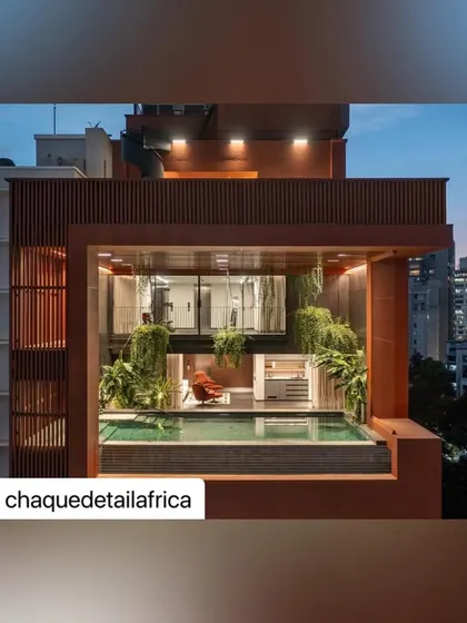 The rooftop lounge at dusk, where architectural lighting and the glow from the city create a magical atmosphere. This is urban outdoor living at its most sophisticated.