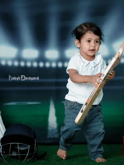 Starting early with a bat in hand and a smile on his face. A future cricket star in the making.