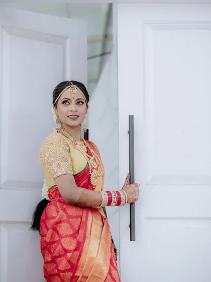 The bride peeking out from a doorway. This playful pose adds a touch of coyness and charm to her bridal photos.