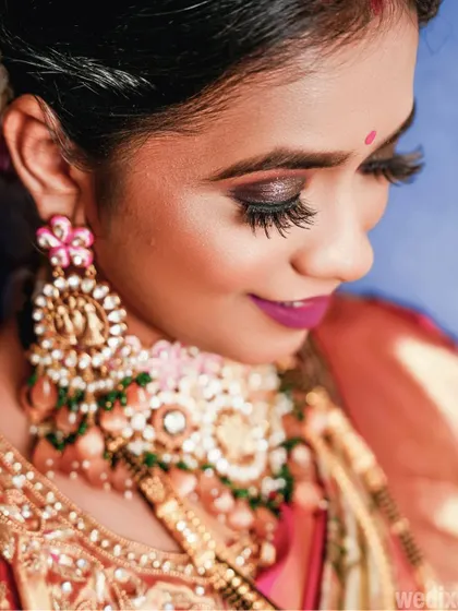A detailed close-up shot of the bride's stunning makeup, focusing on her eye makeup and intricate jewellery.