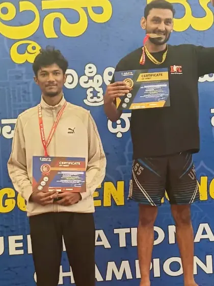 Two of our fighters on the podium, one celebrating his win. The sportsmanship and camaraderie, even among competitors, is a key part of martial arts.