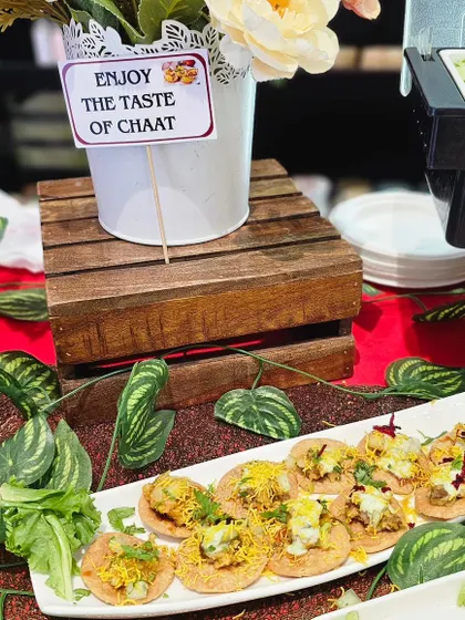 A beautifully arranged platter of papdi chaat, ready to be served at a hi-tea event. The presentation is as important as the taste, ensuring a delightful experience for all guests.