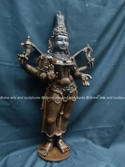 A close-up view of the Bhuvaneswari wax model, highlighting the details of her crown and facial expression before the sculpture is prepared for casting.