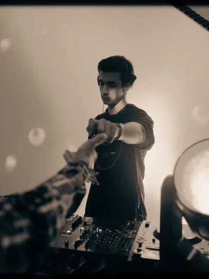 A shot capturing the connection with the crowd. That fist bump is a moment of shared energy between me and someone on the dance floor.