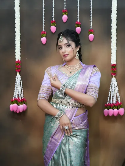 Another full-length pose, showing the beautiful fall of the pastel-coloured saree.