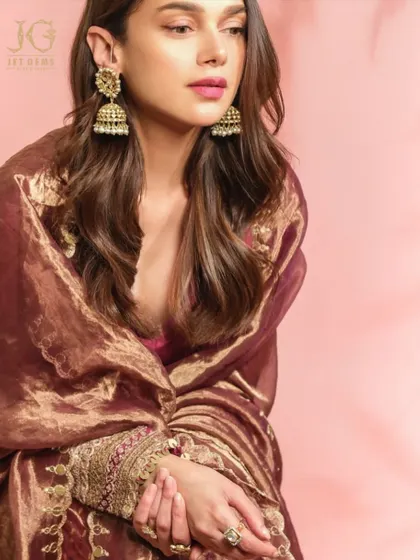 A moment of quiet elegance, with Aditi Rao Hydari showcasing our statement Polki ring and traditional gold jhumkas.