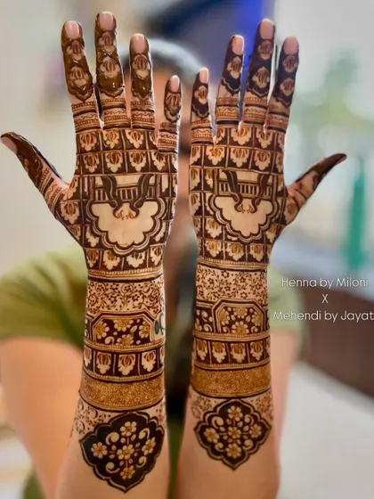 A beautiful bridal design featuring a jharokha with a swing (jhula) inside. The surrounding patterns are a mix of floral and geometric elements.
