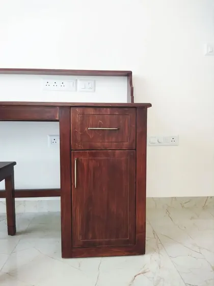A duplicate of image 109, showing the simple yet elegant storage cabinet next to the desk.