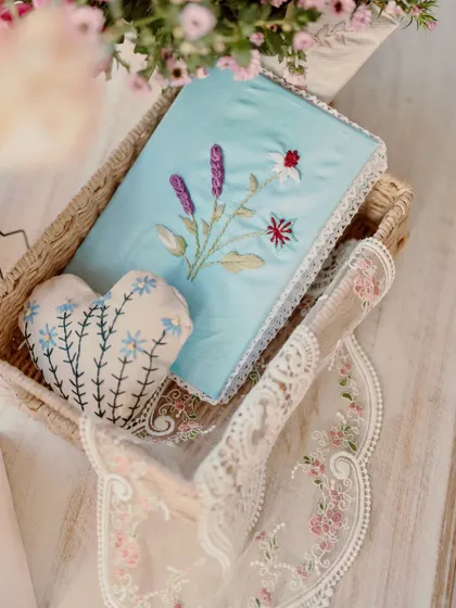Beautifully handcrafted and embroidered pouches and pillows used as decor elements.