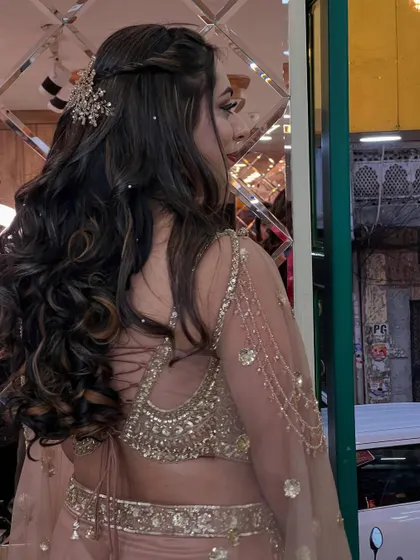 A side profile showing how the hairstyle and accessory complement the intricate design of her blouse.