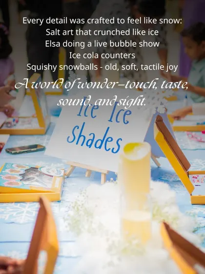 An activity table set up for the Frozen party, with a sign for "Ice Ice Shades" and salt art kits for the children to create their own winter-themed masterpieces.