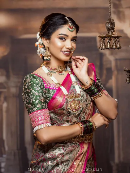 This is another one of my favorite floral sarees. The pink and green accents in the blouse bring out the subtle colors in the silver-grey brocade fabric.