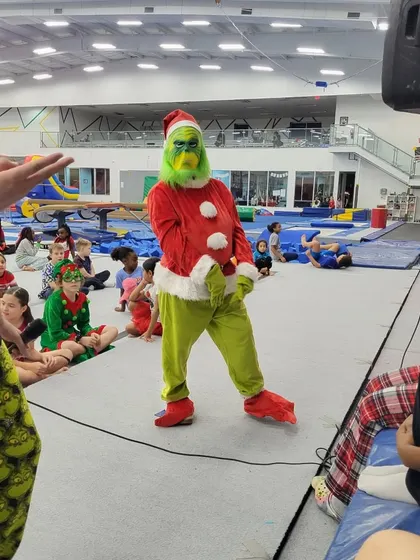 Look who crashed our party! The Grinch himself making a special appearance at our Grinchmas event, delighting a crowd of excited children.