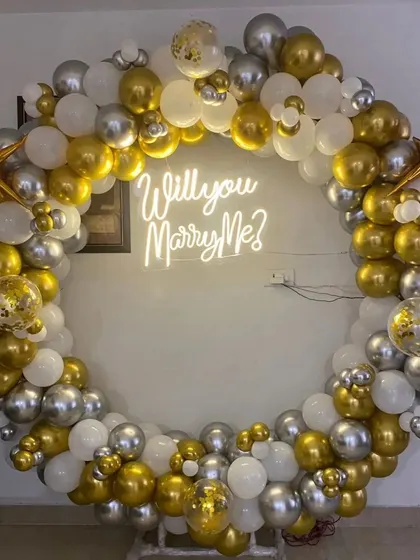A close-up of the proposal balloon ring, showing the detail of the confetti and chrome balloons.