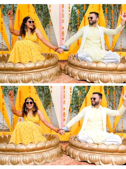 A fun and quirky shot of the couple posing in large lotus-shaped seats at their Haldi ceremony. Their playful poses capture the lighthearted spirit of the event.