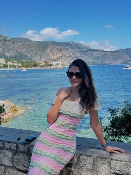 Soaking up the sun in Villefranche-sur-Mer in the South of France. This colorful knit dress is perfect for a coastal vacation, offering a playful yet chic look against the stunning blue water.