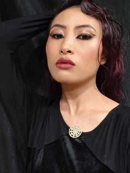 A confident pose that captures the edgy and contemporary feel of the glossy makeup look.