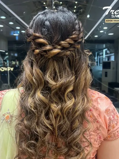 A detailed look at the beautiful braided and curled hairstyle, perfect for a wedding or special event.
