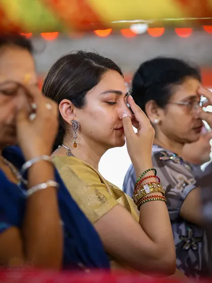 A participant practices a breathing technique during a Rishi Homa. The combination of ancient rituals and yogic practices creates a holistic experience for spiritual growth.