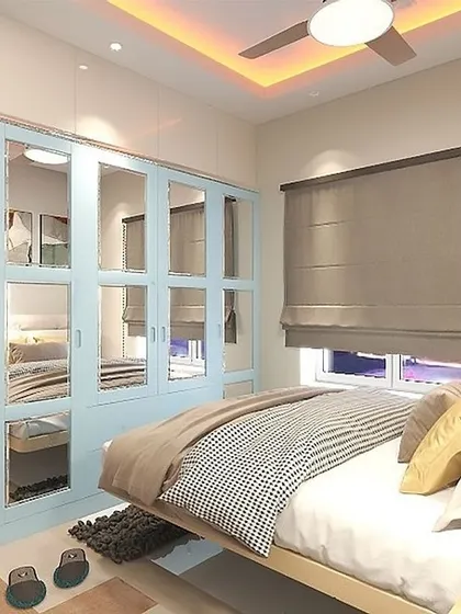 This bedroom features a mirrored wardrobe in a soft blue, adding a sense of space and playfulness.