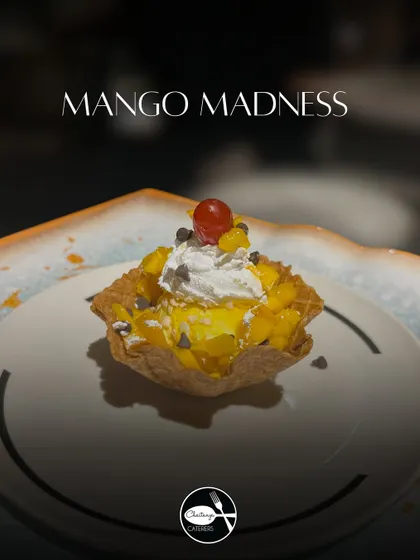 Mango madness in a waffle cup! This dessert is loaded with mango ice cream, juicy mango chunks, whipped cream, and a sprinkle of choco chips for a delightful crunch.