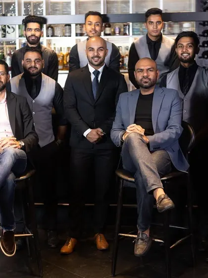 Crafting the perfect cocktail, one sip at a time. Our expert mixologists, the heart and soul of Lair, pose for a team photo at the bar.