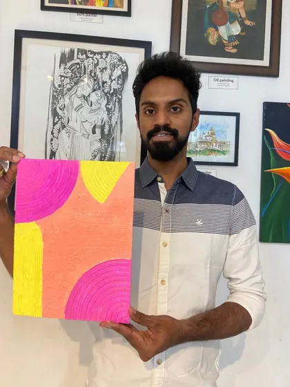 A participant with his colorful abstract texture painting. The workshop is a great way to explore color theory and composition.