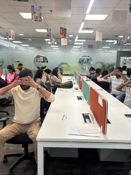 A wider view of the team at MagicBricks practicing an eye relaxation technique. These small breaks can make a big difference in preventing headaches and fatigue from screen time.