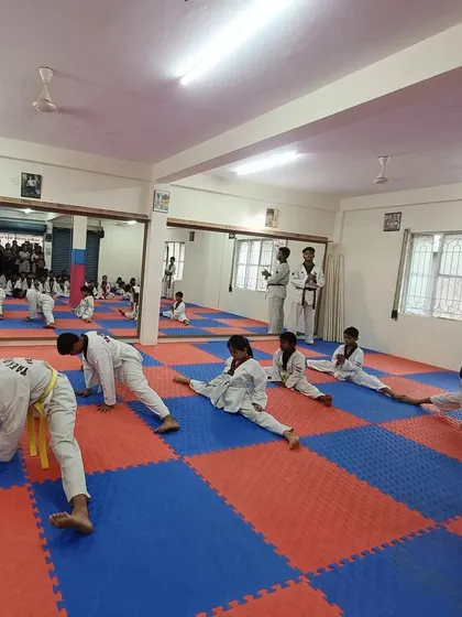 The entire class is focused on their stretching exercises.