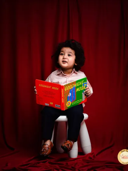 A quiet moment with a good book. This "little scholar" theme is a sweet and unique way to capture a child's curious and thoughtful side.