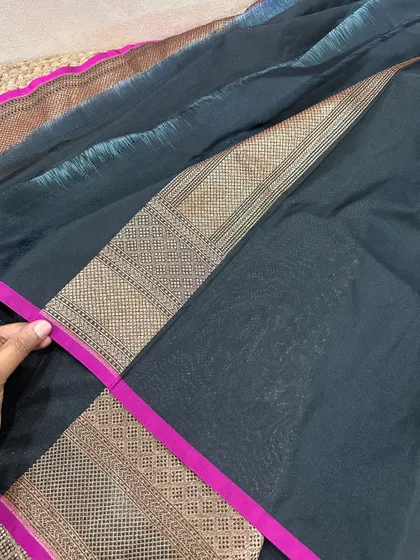 A look at the simple yet elegant black blouse piece with a striking pink border from one of our contrast combination sarees.