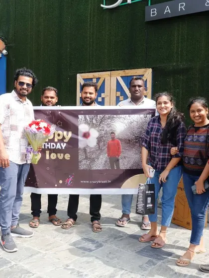Our happy clients posing with a custom birthday banner after a successful flashmob. Seeing these smiles is why we do what we do.