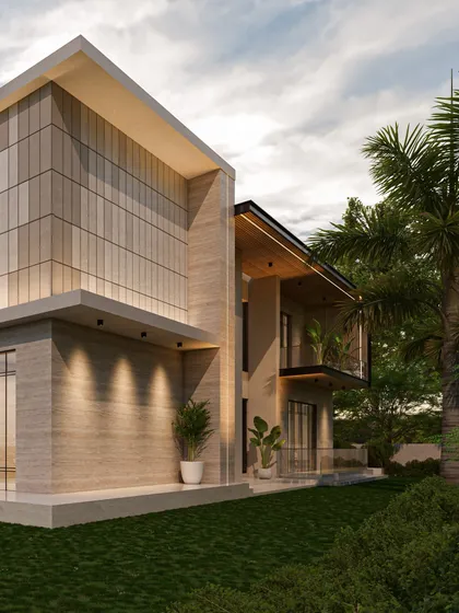 A side view of this contemporary residence highlights the textural contrast between smooth plaster and vertically grooved stone cladding. The warm exterior lighting accentuates these details, giving the facade a soft glow at dusk.