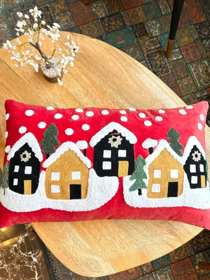 Another view of our winter village Christmas cushion cover. The vibrant red and snowy details make it a perfect piece of cozy holiday decor.